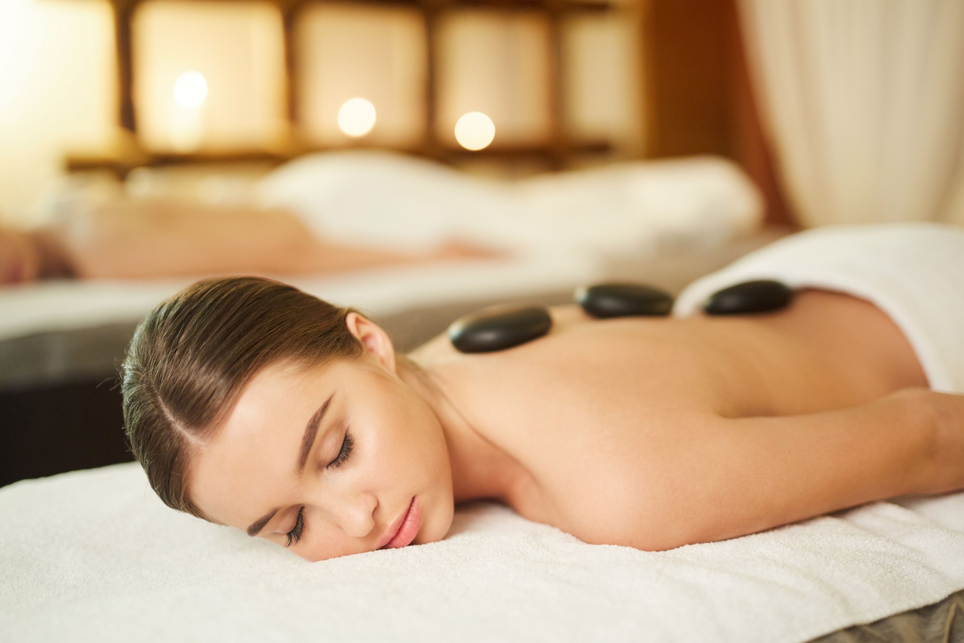Beautiful Woman Enjoyinf Stone Therapy in Luxury SPA